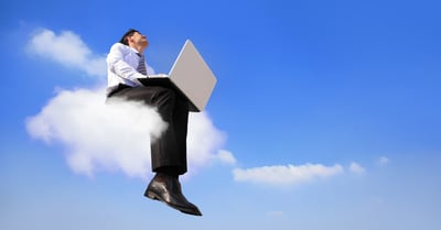 Business person sitting on cloud