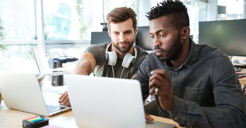 A male IT consultant works with a business owner on improving their infrastructure and capabilities over time. 