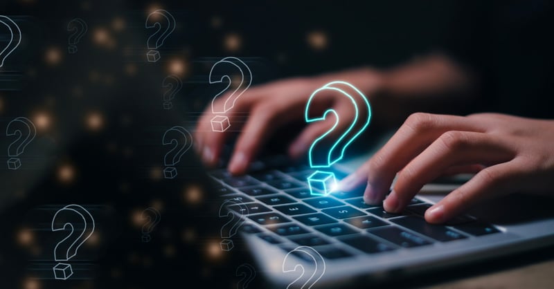 A female employee types in common IT consulting questions on her laptop. 