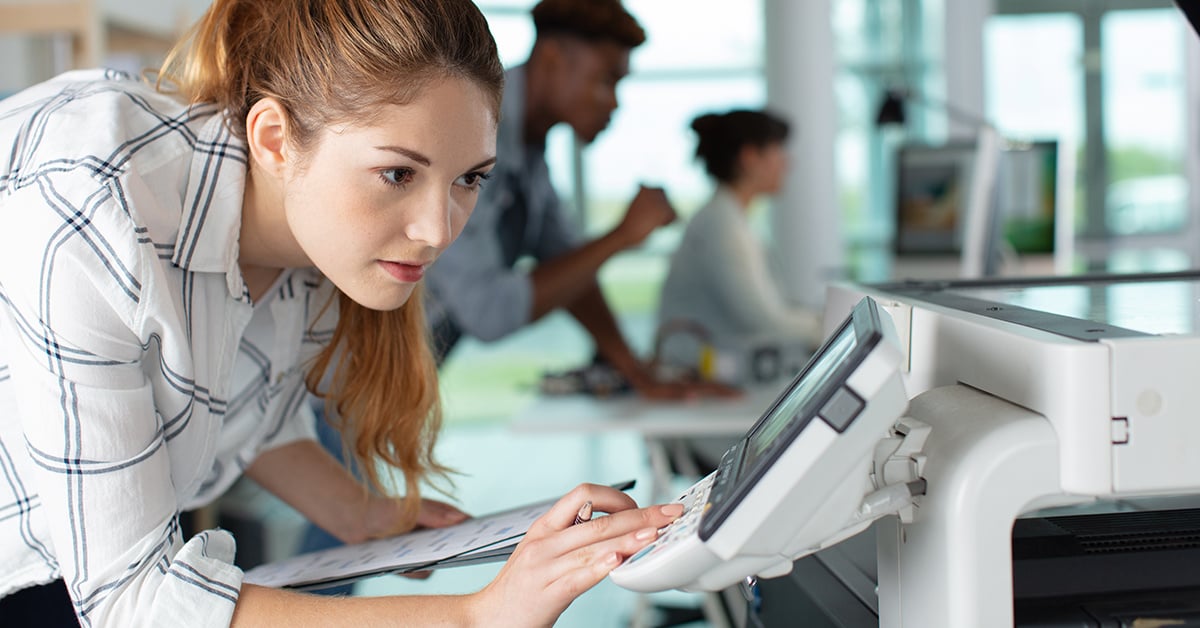 Employee checking printer.