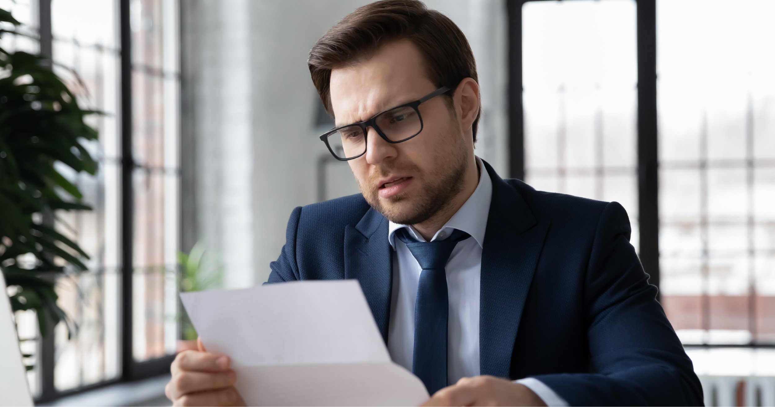 Unhappy business owner looking at bill. 