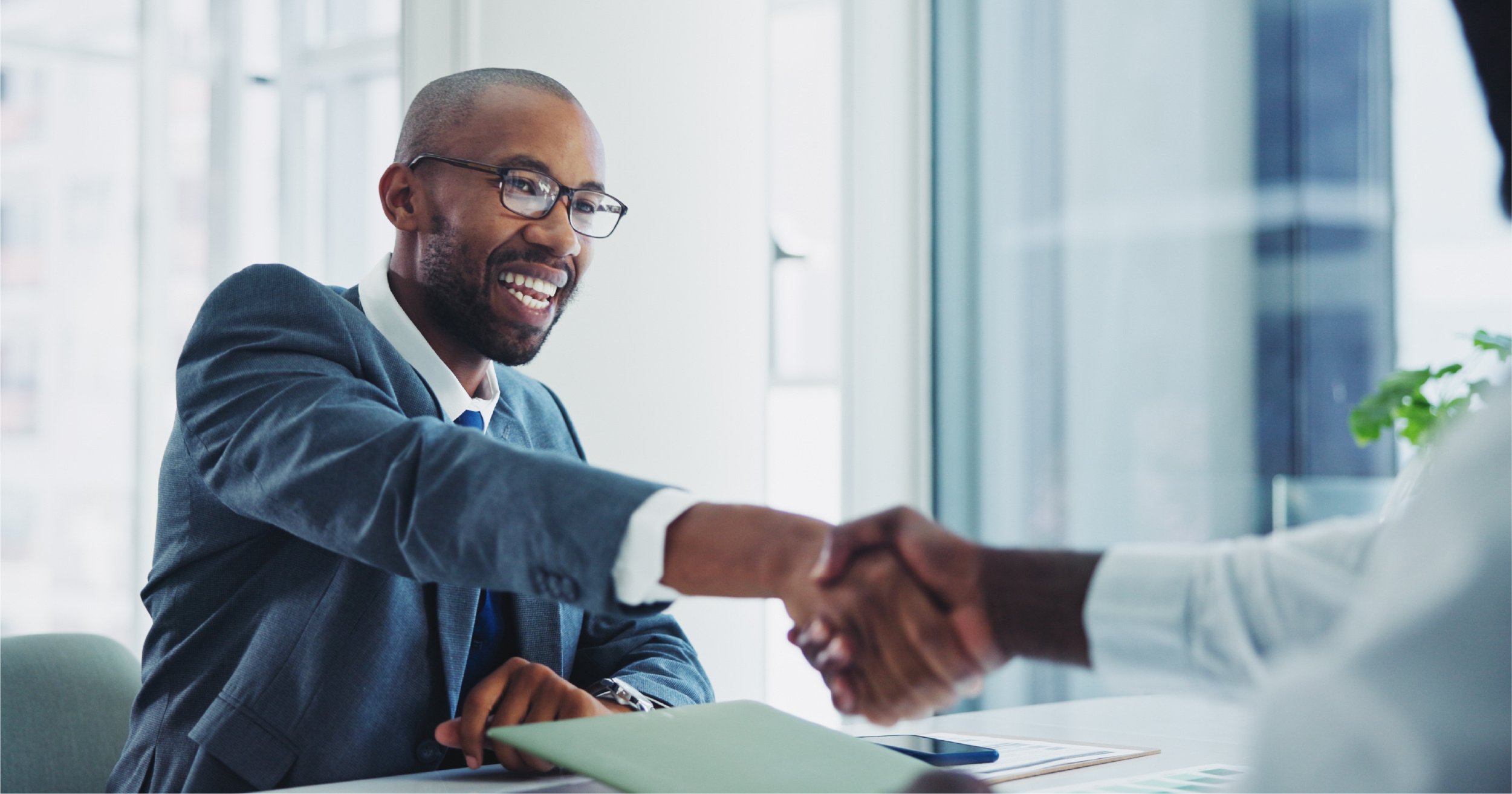CIO shaking hands with business owner.