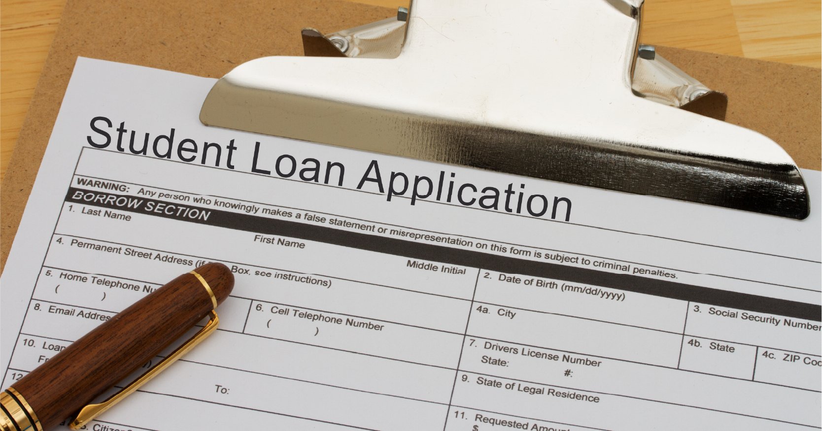 Student loan application on clipboard.