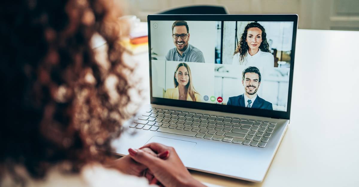 A female employee on a teleconferencing platform with four coworkers