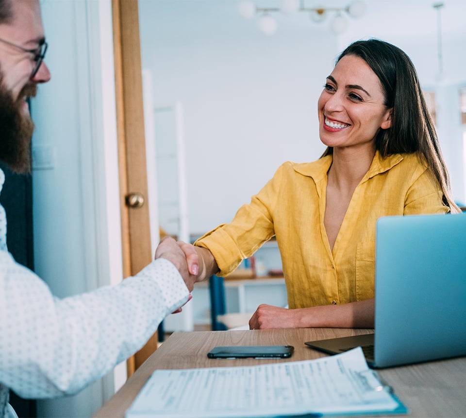 Two individuals shaking hands