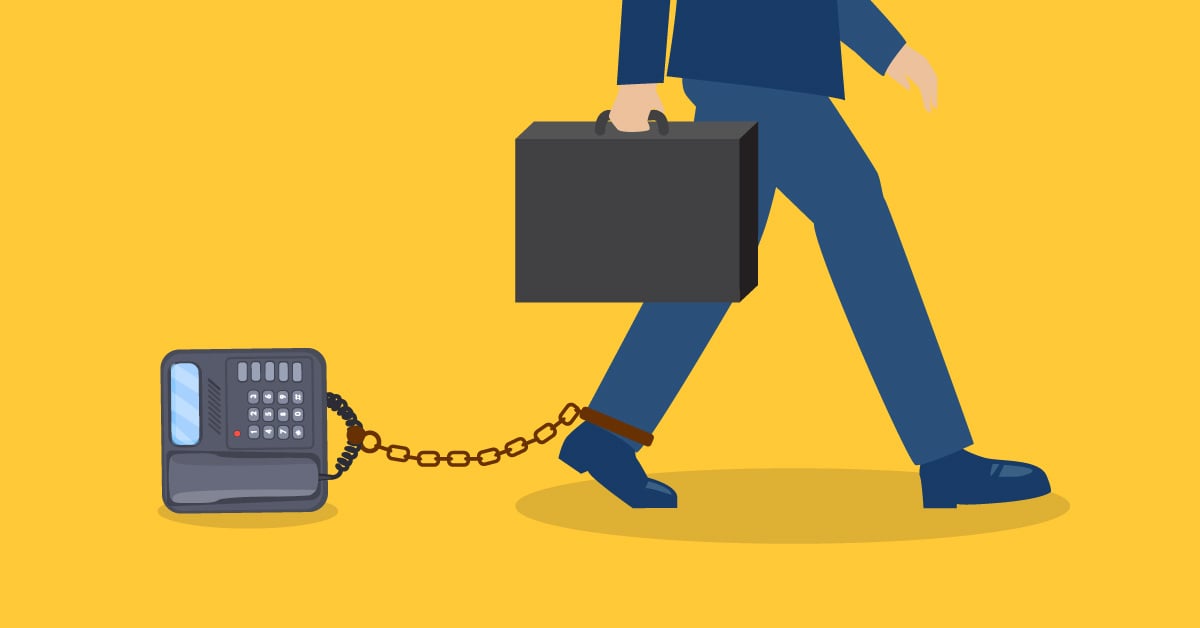 Business man chained to old phone