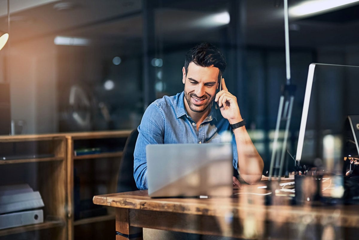 Smiling person calling on phone