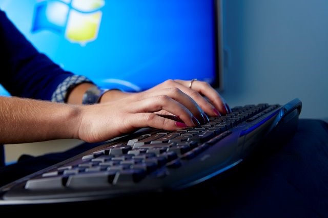 Hands typing on keyboard