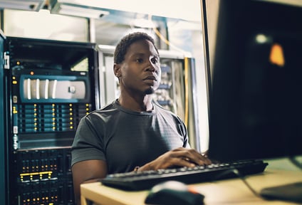 man sitting at computer
