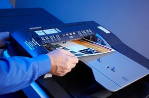 individual making color copies on a multifunction printer