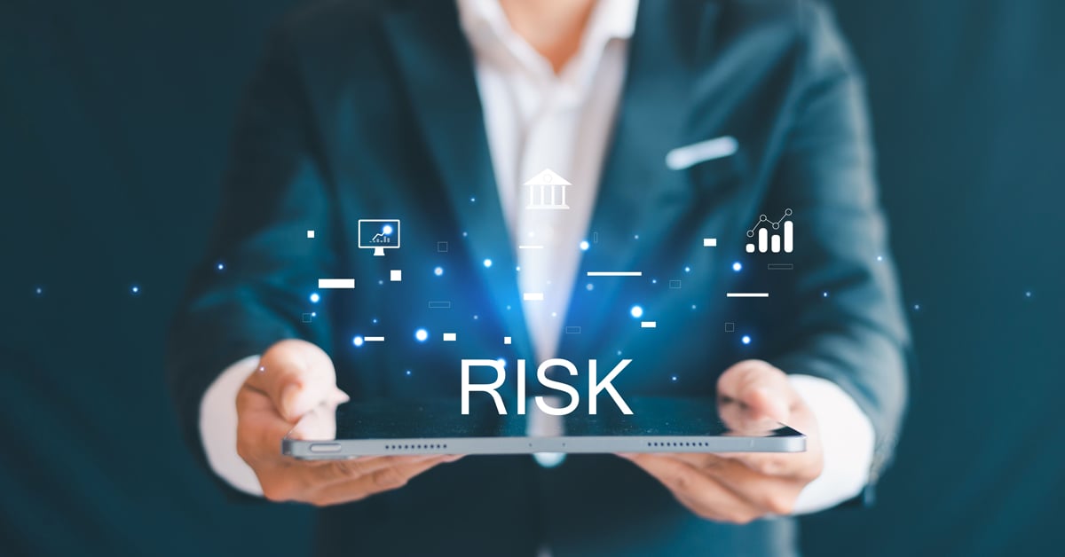 Person holding tablet with IT risk variable graphics. 