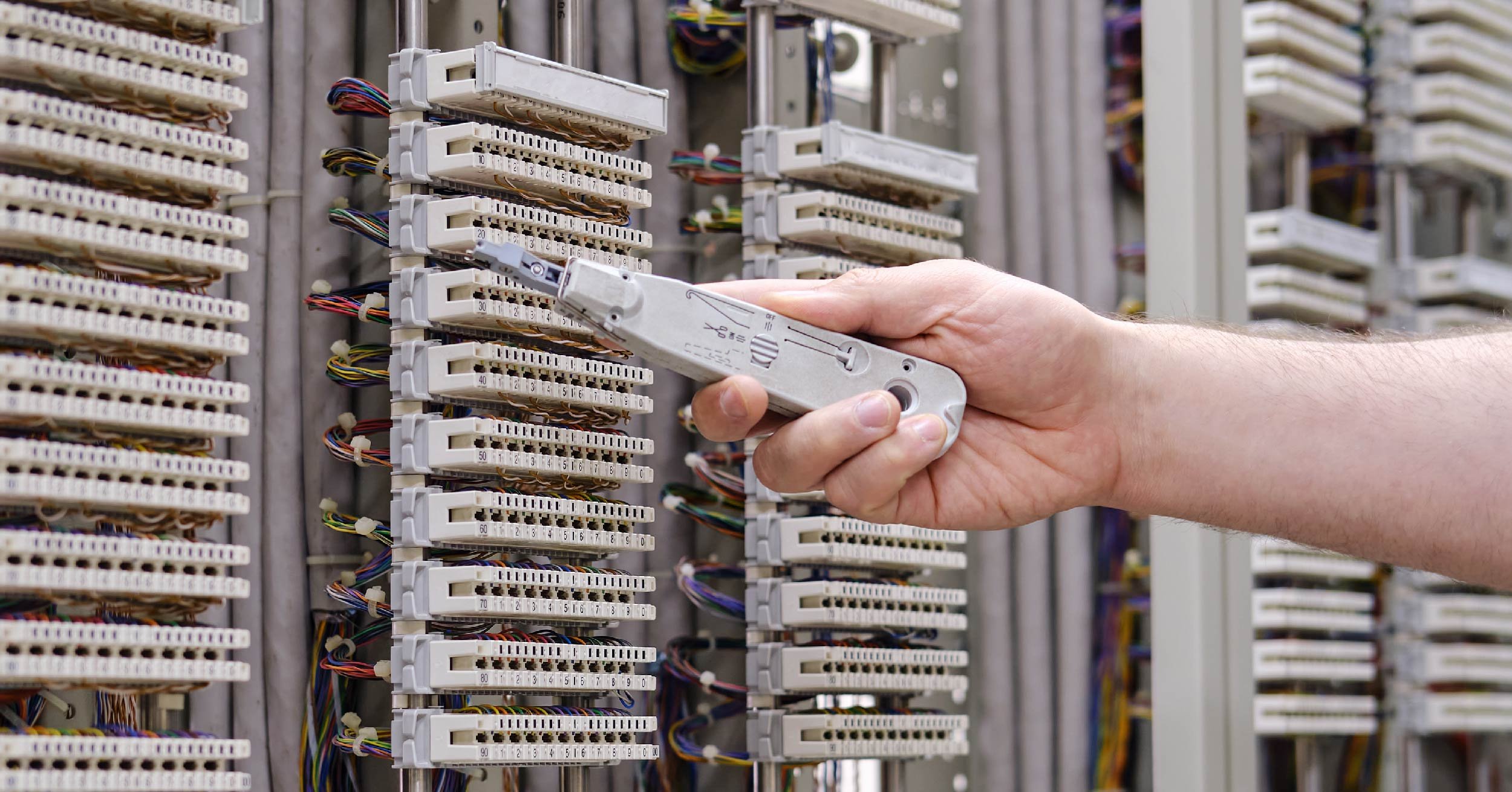 technician-fixing-phone-system