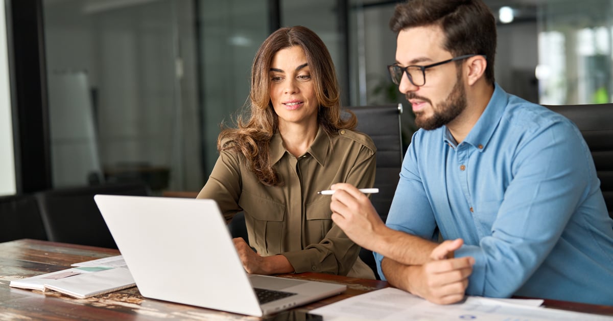 Two lawyers working together on computer. 