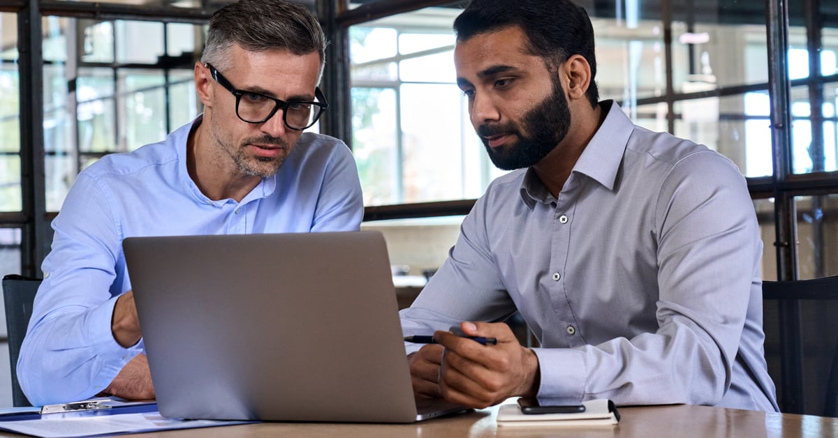 Two analysts working on computer. 