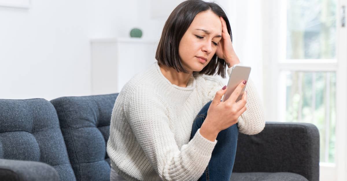 Frustrated woman on hold to schedule medical appointment. 