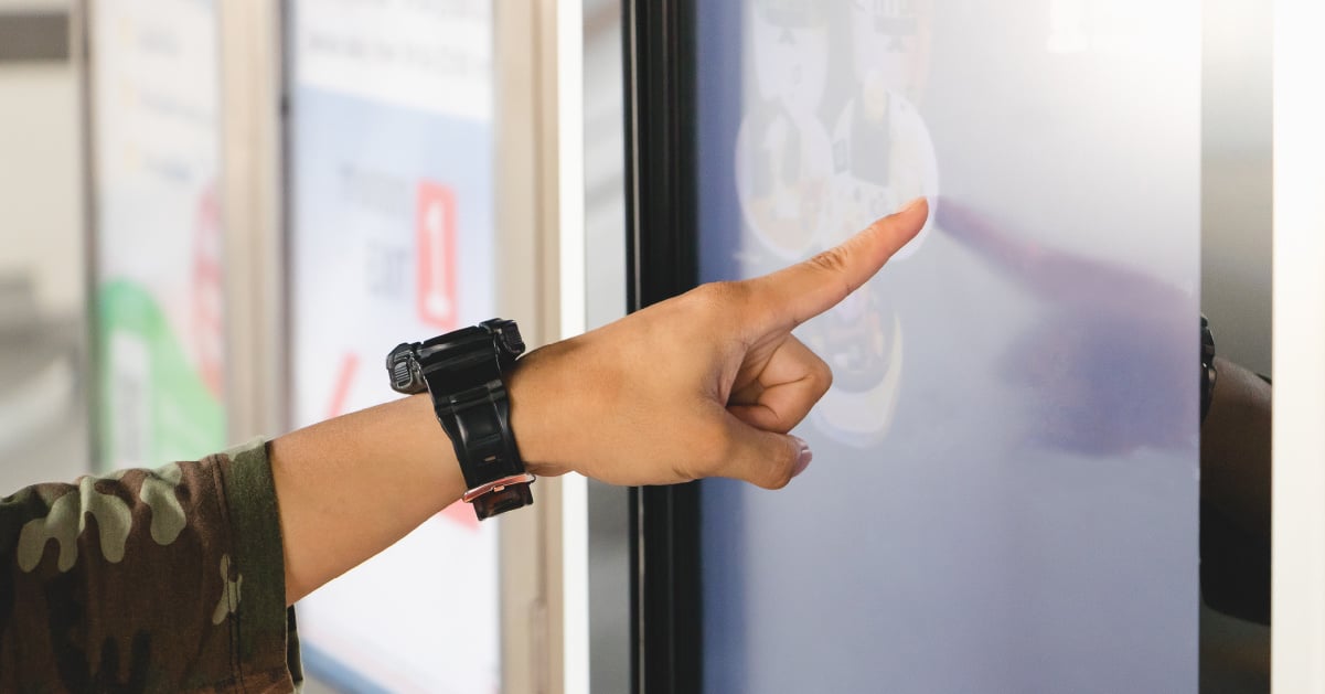 A student uses interactive digital signage to help them navigate a new college campus and find helpful resources and information.